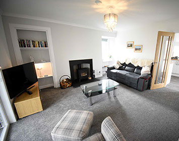 Tigh Beag Na Mara Self Catering Accommodation Living Room with Smart TV Woodburning Stove Sea Views and WIFI Internet access